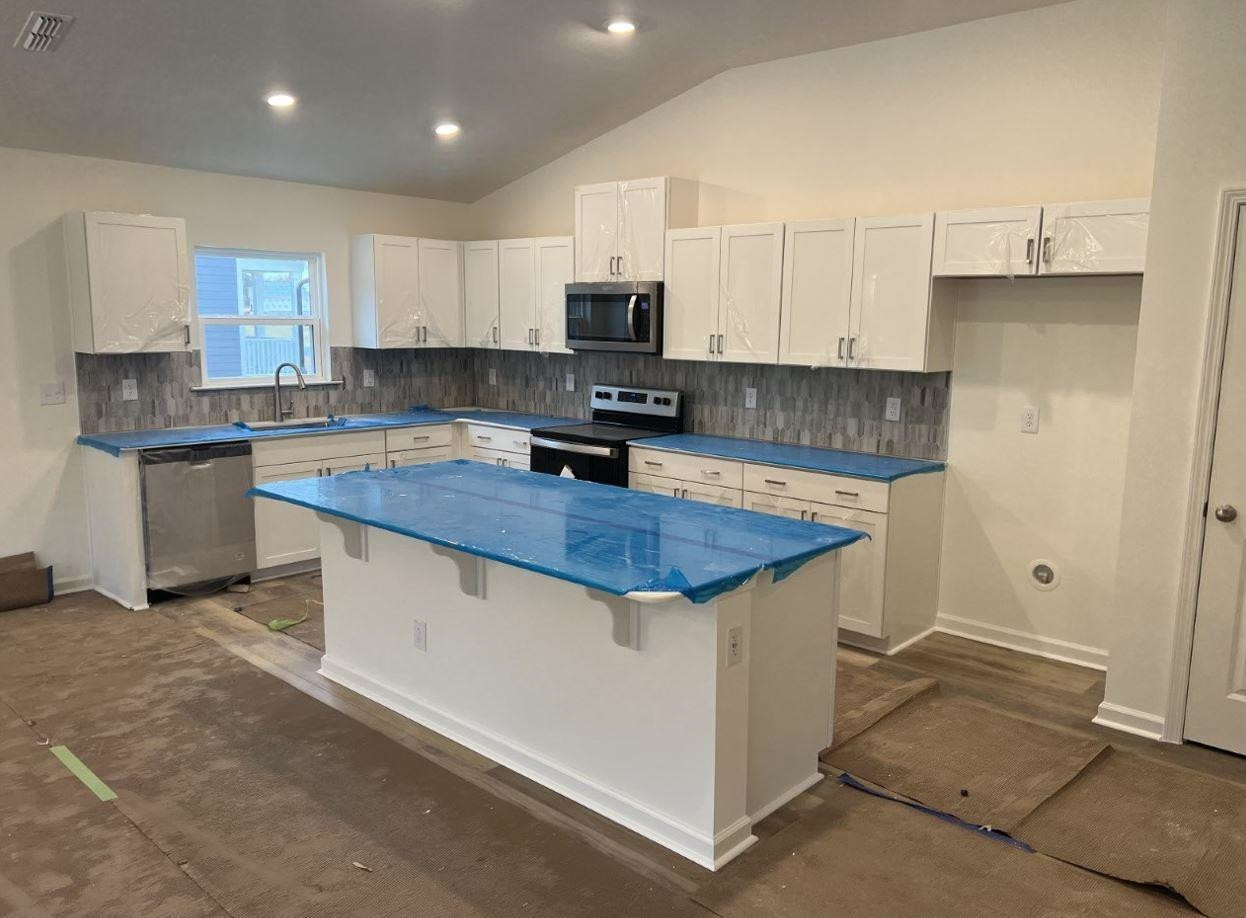 1501 Willow Lndg Way Willow Spring, NC 27592 - Photo 3 of 15 a kitchen with stainless steel appliances granite countertop a sink stove and refrigerator
