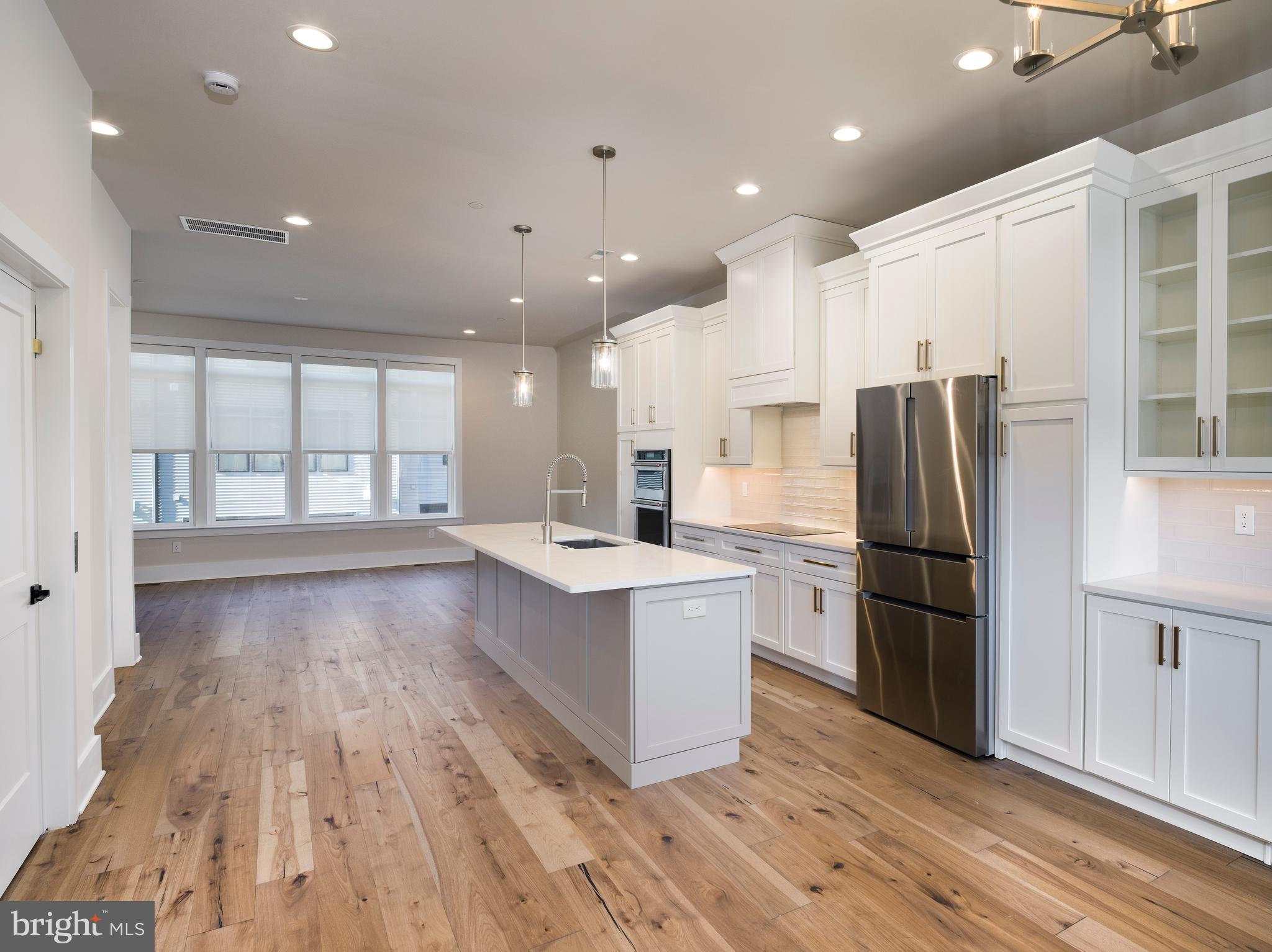 354 Paddock Circle Newtown Square, PA 19073 - Photo 11 of 36 a large kitchen with stainless steel appliances a large counter top and wooden floors