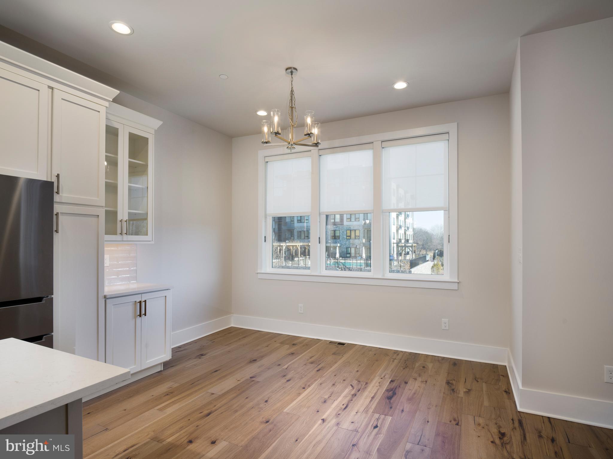 354 Paddock Circle Newtown Square, PA 19073 - Photo 13 of 36 a view of an empty room with wooden floor and a window