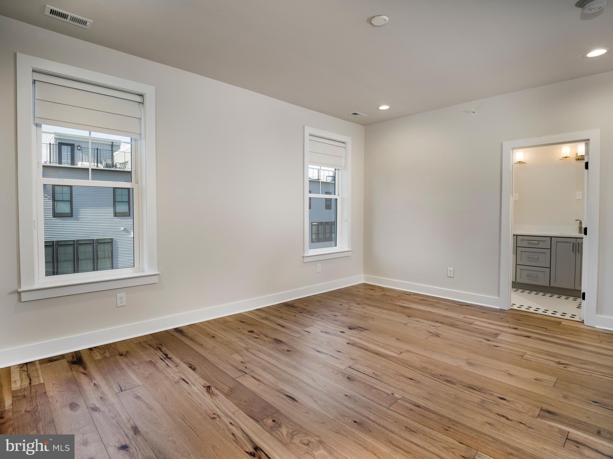354 Paddock Circle Newtown Square, PA 19073 - Photo 16 of 36 a view of an empty room with wooden floor and a window