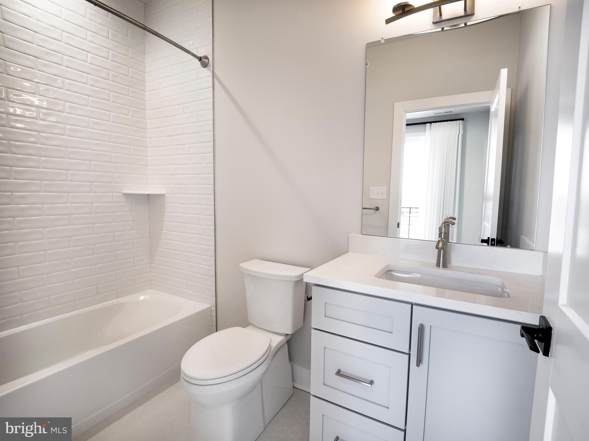 354 Paddock Circle Newtown Square, PA 19073 - Photo 22 of 36 a bathroom with a sink toilet vanity and shower