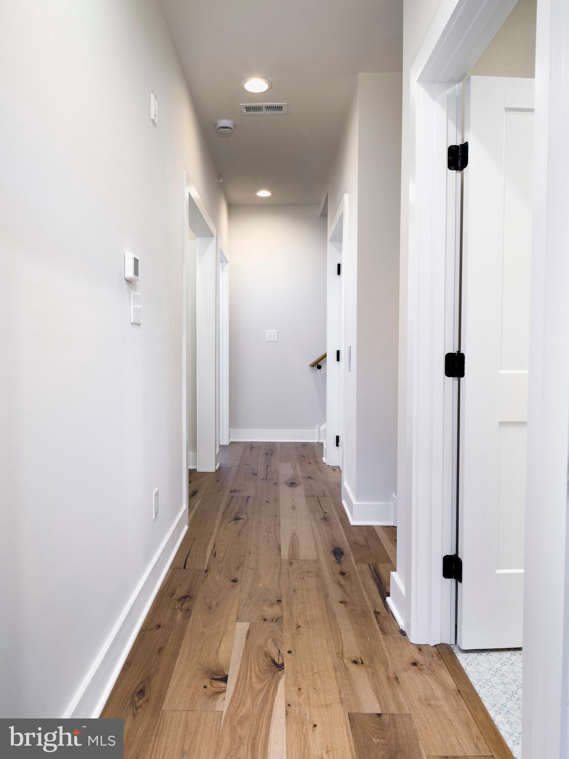 354 Paddock Circle Newtown Square, PA 19073 - Photo 24 of 36 a view of a hallway with wooden floor and staircase