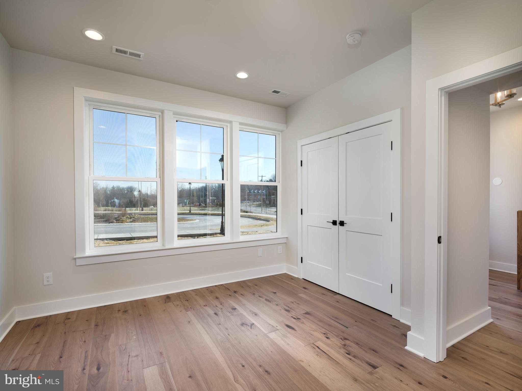 354 Paddock Circle Newtown Square, PA 19073 - Photo 4 of 36 a view of an empty room with wooden floor and a window
