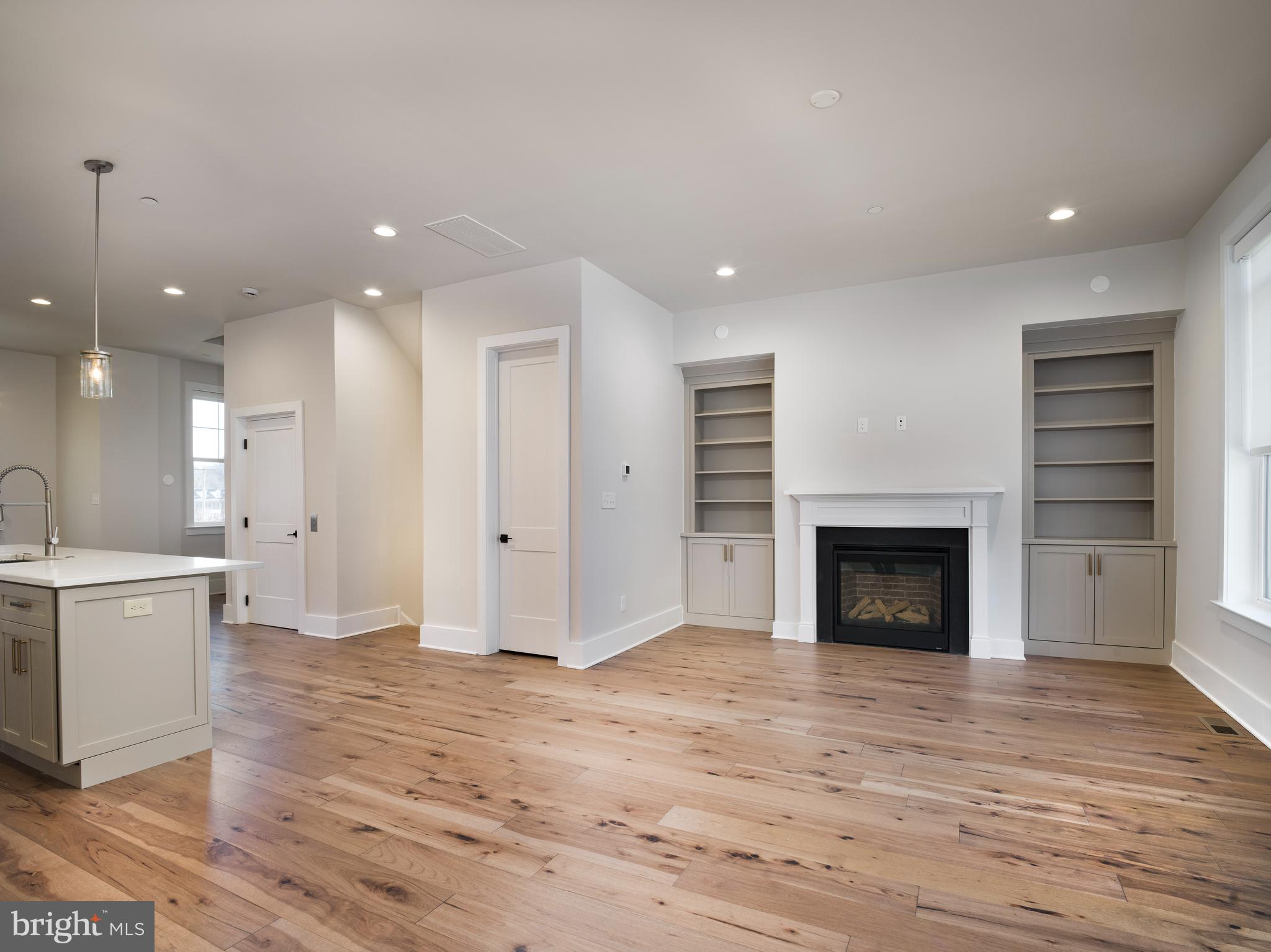 354 Paddock Circle Newtown Square, PA 19073 - Photo 8 of 36 an empty room with wooden floor and a fireplace