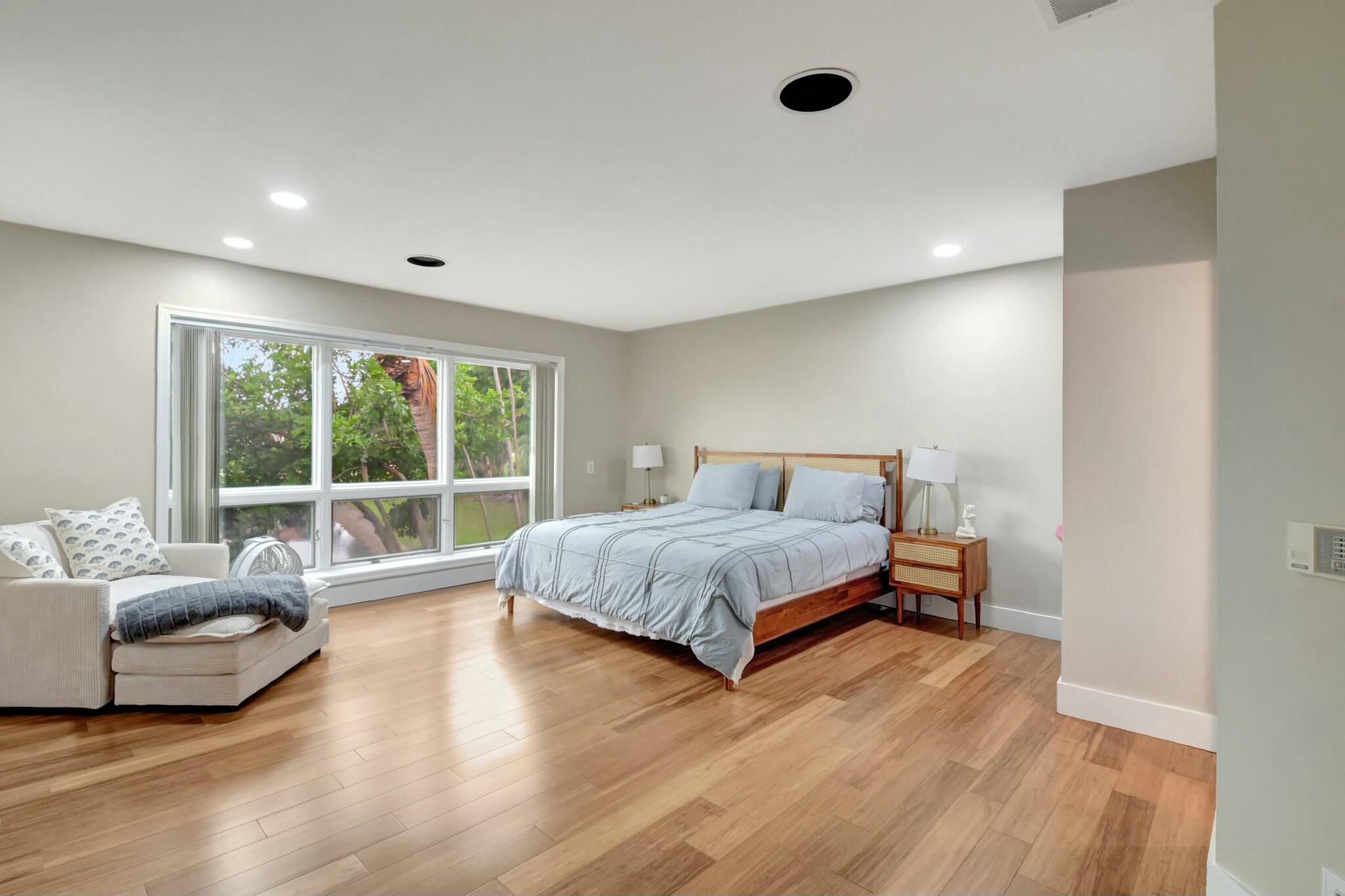 7860 Seville Place, Unit 2202 Boca Raton, FL 33433 - Photo 12 of 30 a spacious bedroom with a bed and a large window