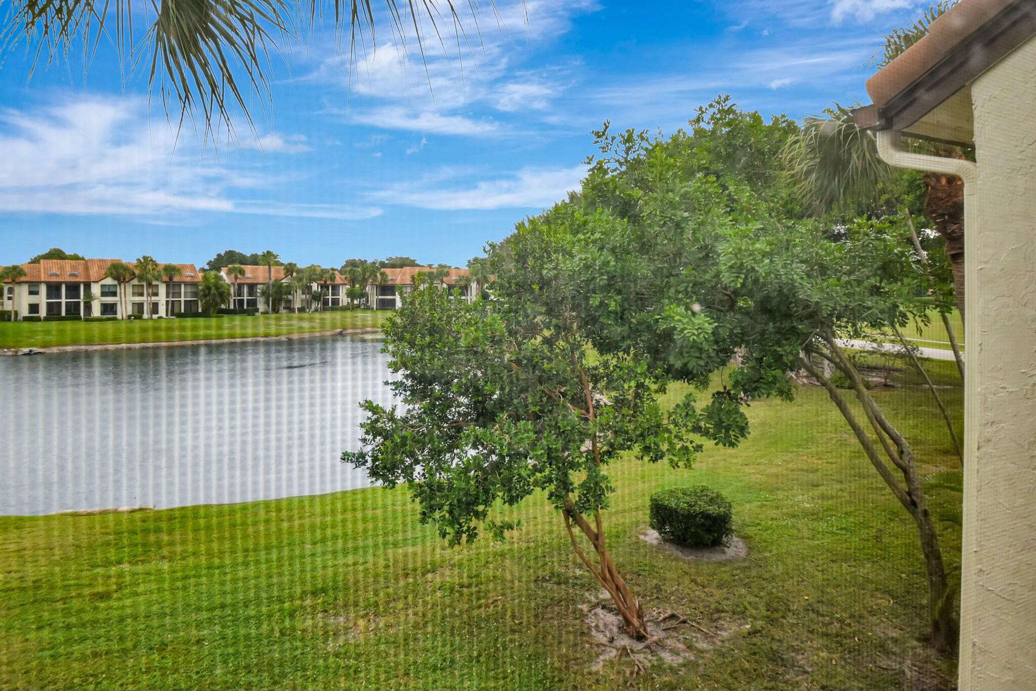 7860 Seville Place, Unit 2202 Boca Raton, FL 33433 - Photo 29 of 30 a view of a lake with a yard