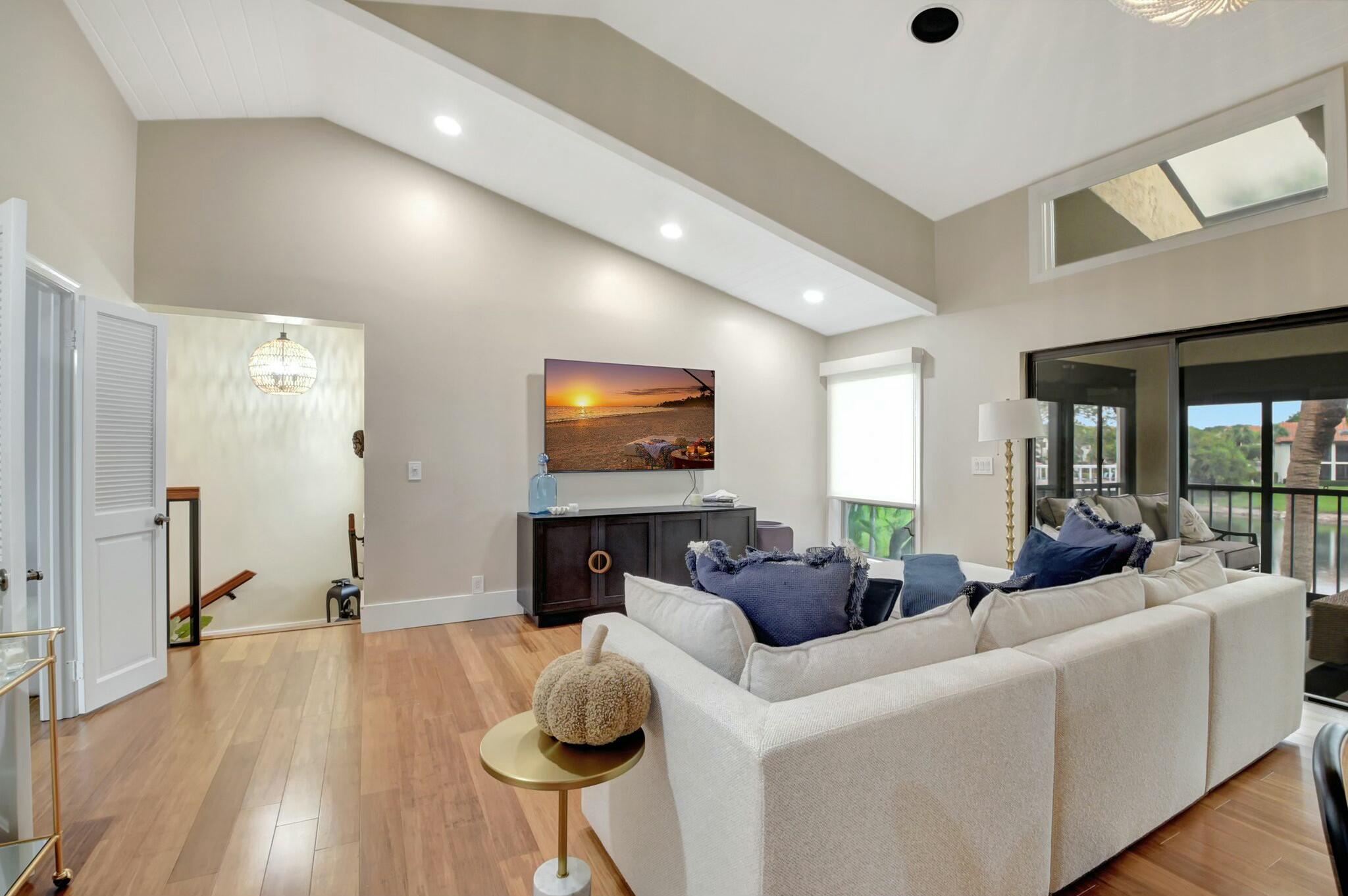 7860 Seville Place, Unit 2202 Boca Raton, FL 33433 - Photo 6 of 30 a living room with furniture and a flat screen tv