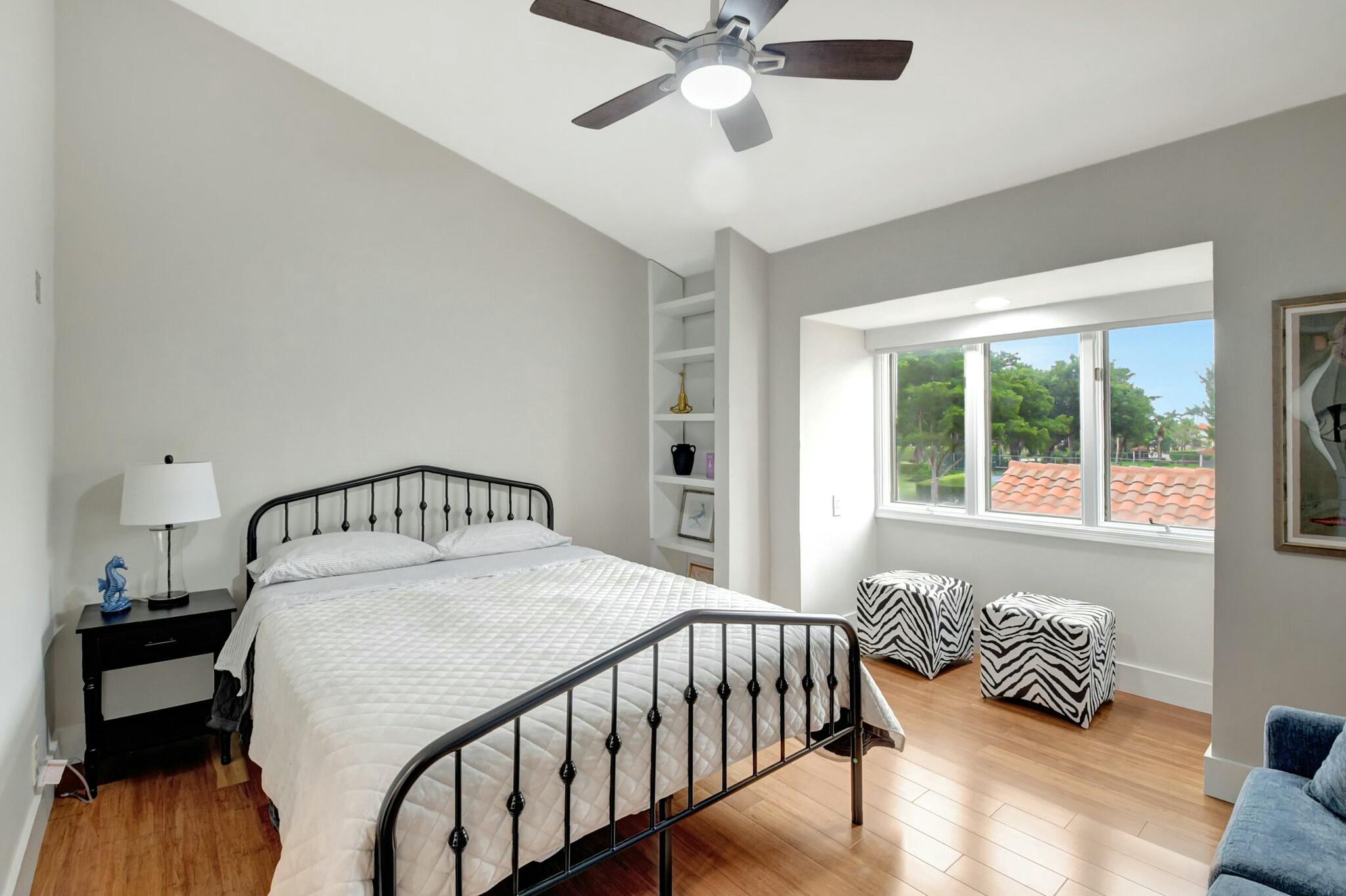 7860 Seville Place, Unit 2202 Boca Raton, FL 33433 - Photo 8 of 30 a bedroom with a bed and a window