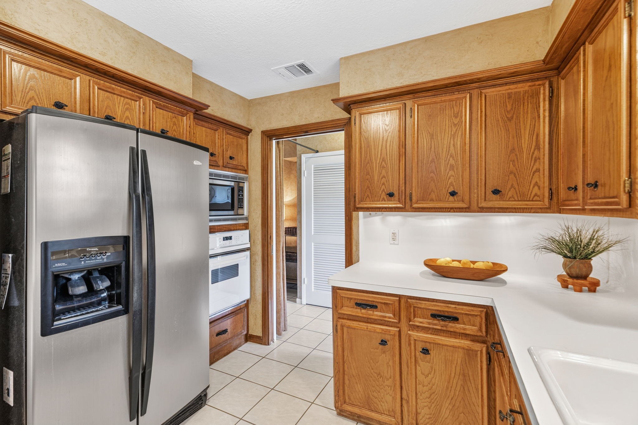 3414 Flaming Candle Drive Spring, TX 77388 - Photo 20 of 50 KITCHEN - Refrigerator to remain with the home. To the right of the refrigerator is the oven and a microwave oven above.