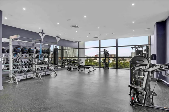 a view of a lobby with gym equipment and floor to ceiling window