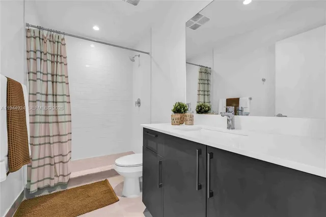 a living room with furniture and flowers