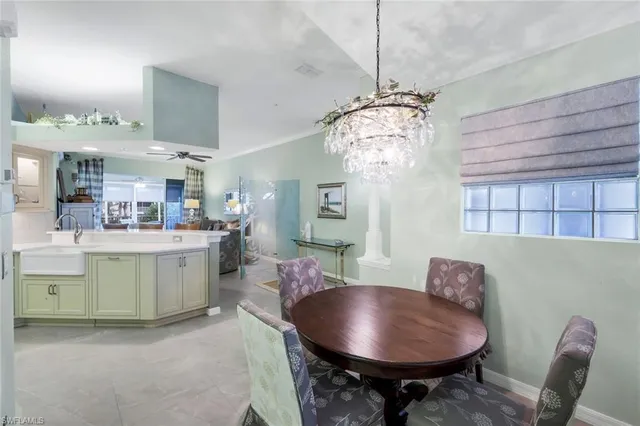 a view of a dining room with furniture and chandelier