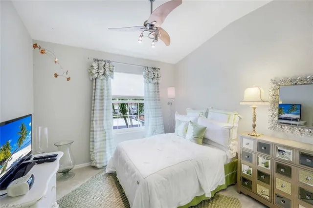 a bedroom with a bed and a tv on the dresser