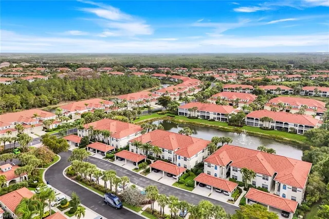 an aerial view of residential houses with outdoor space and seating