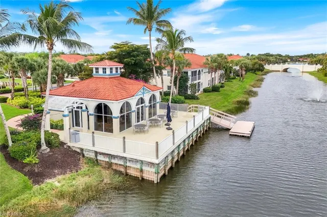 a view of a white house with a yard and sitting area