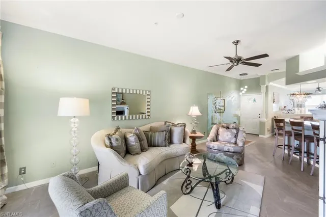 a living room with furniture and a ceiling fan