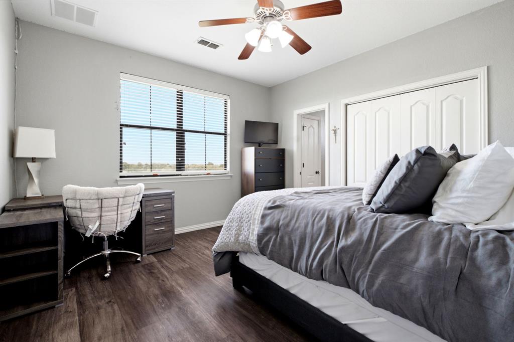 600 Aspen Street Pilot Point, TX 76258 - Photo 24 of 39 Spacious room featuring wood-finish flooring, a ceiling fan with integrated lighting, and a large window with horizontal blinds