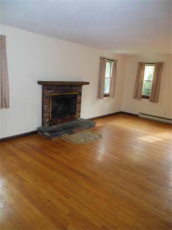 304 Edgewood Road West Springfield, MA 01089 - Photo 5 of 26 an empty room with wooden floor fireplace and windows