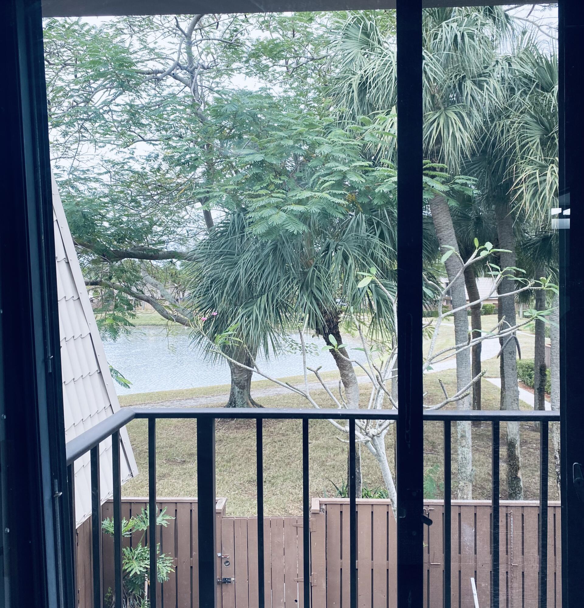 5808 58th Way West Palm Beach, FL 33409 - Photo 11 of 23 a view of balcony with wooden floor