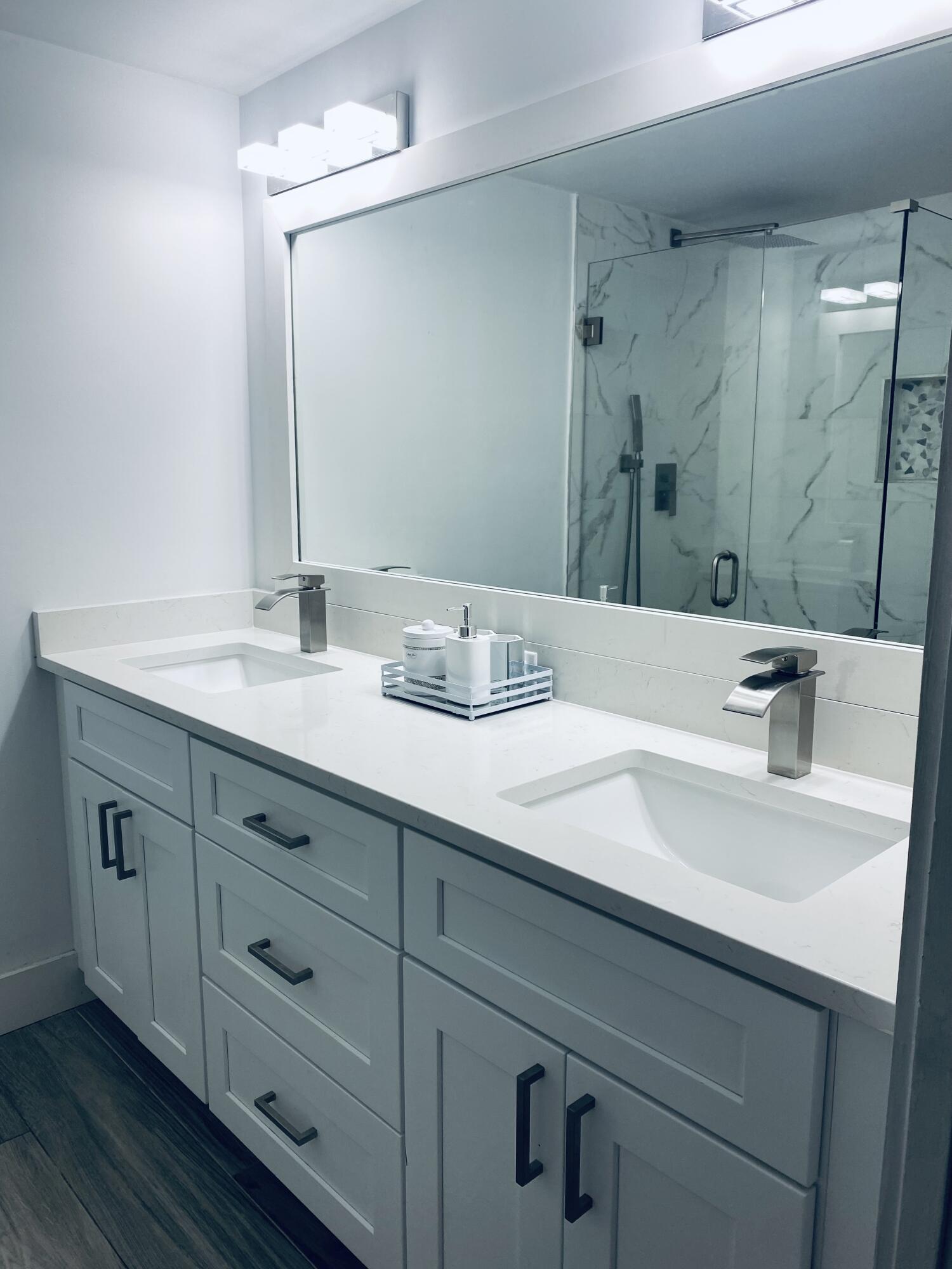 5808 58th Way West Palm Beach, FL 33409 - Photo 12 of 23 a bathroom with double sink and a mirror