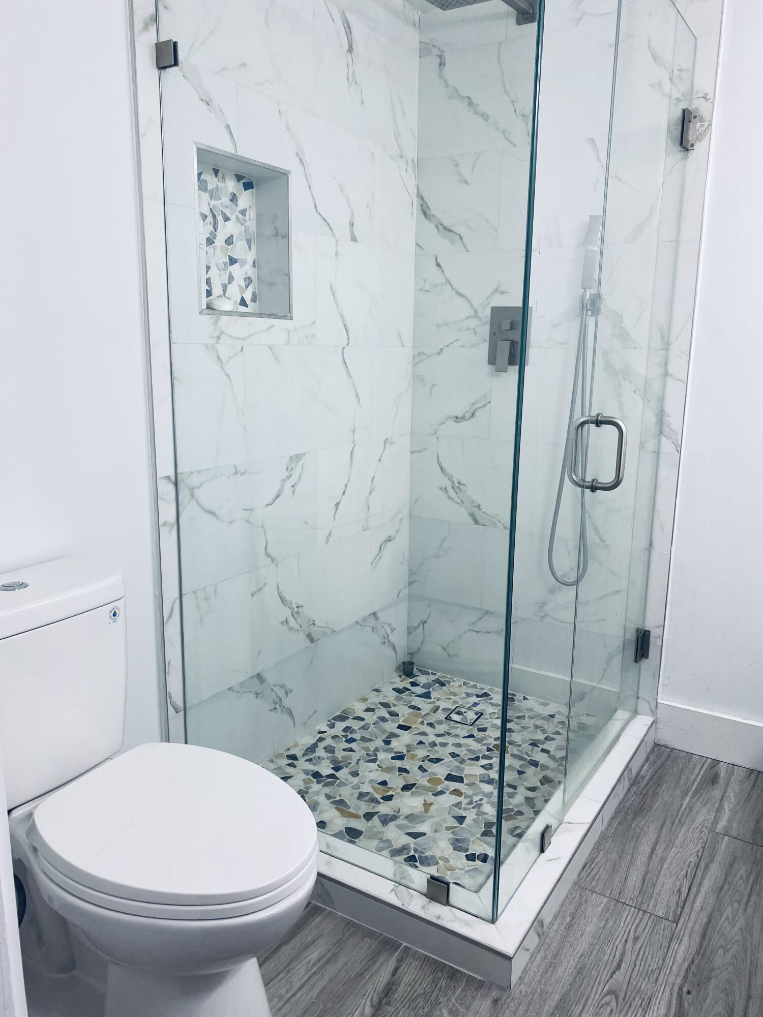 5808 58th Way West Palm Beach, FL 33409 - Photo 13 of 23 a bathroom with a toilet and shower