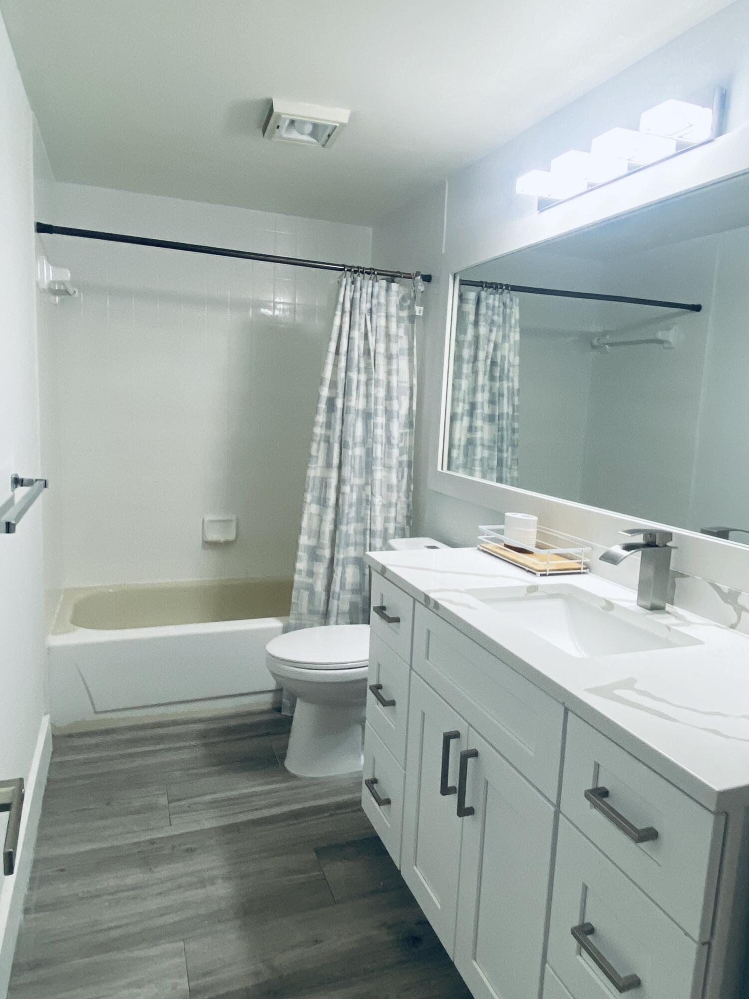5808 58th Way West Palm Beach, FL 33409 - Photo 15 of 23 a bathroom with a sink a toilet and a bathtub
