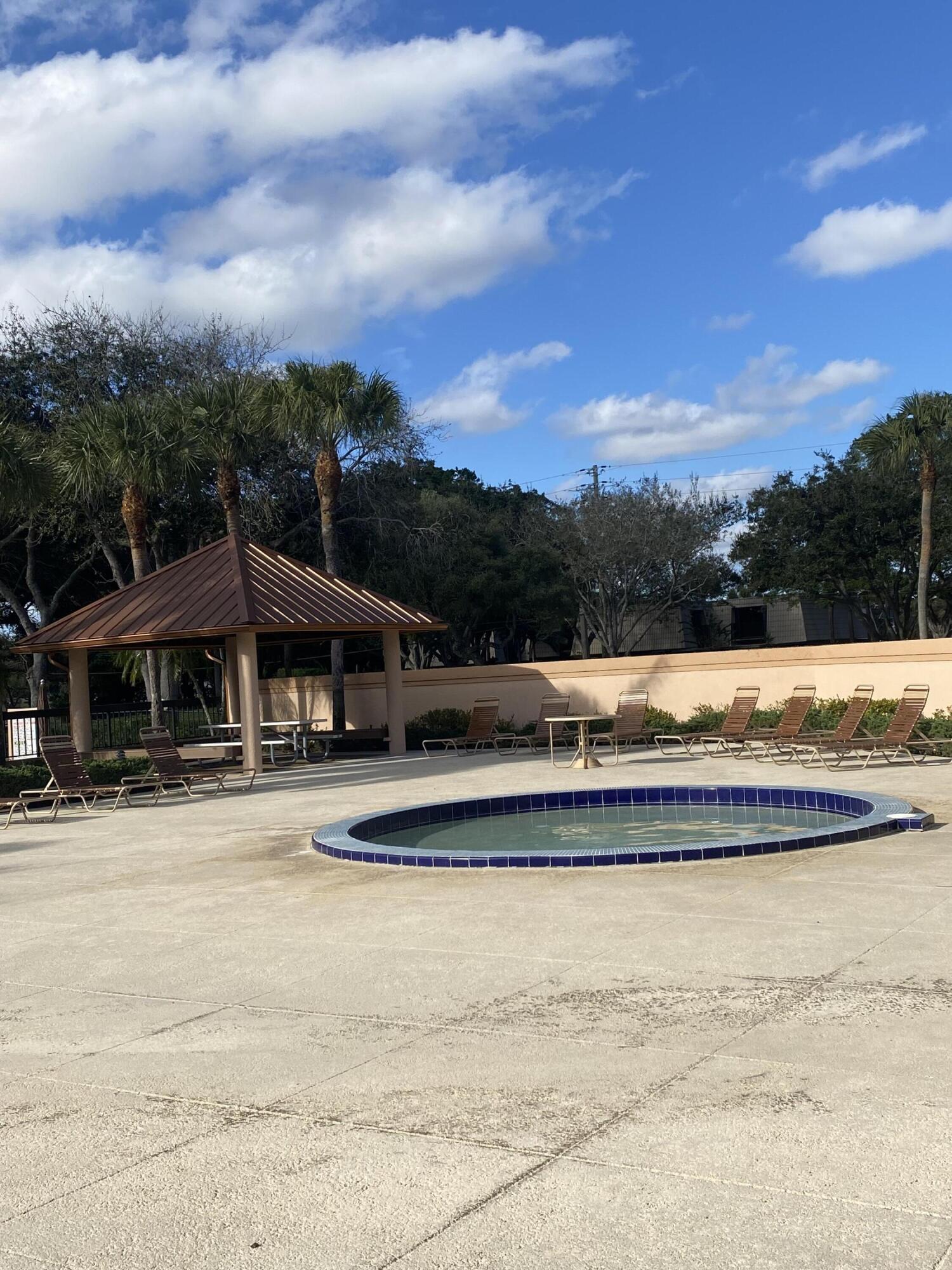 5808 58th Way West Palm Beach, FL 33409 - Photo 21 of 23 a view of swimming pool with trees in the background
