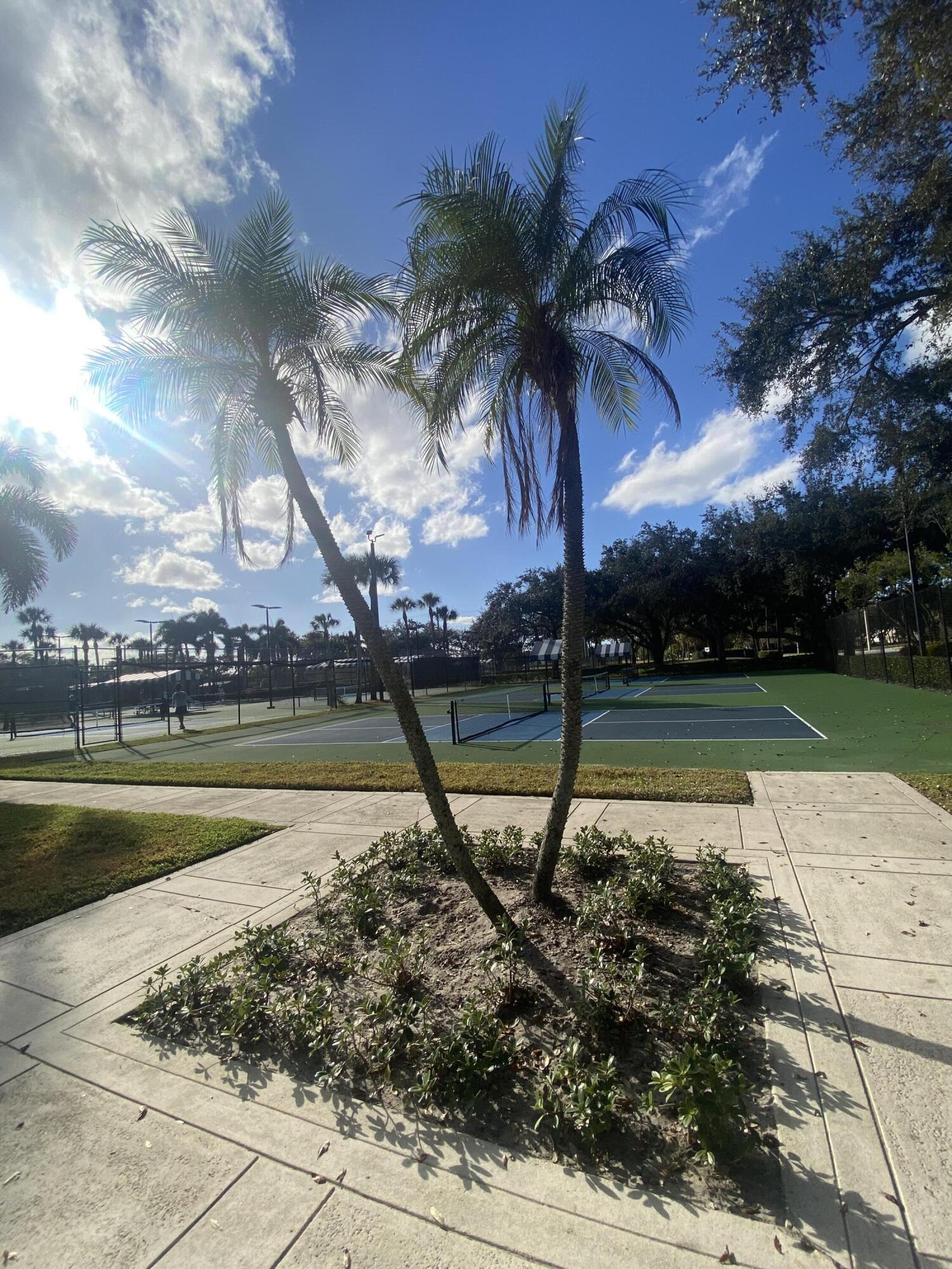 5808 58th Way West Palm Beach, FL 33409 - Photo 23 of 23 a view of a swimming pool with a table and chairs