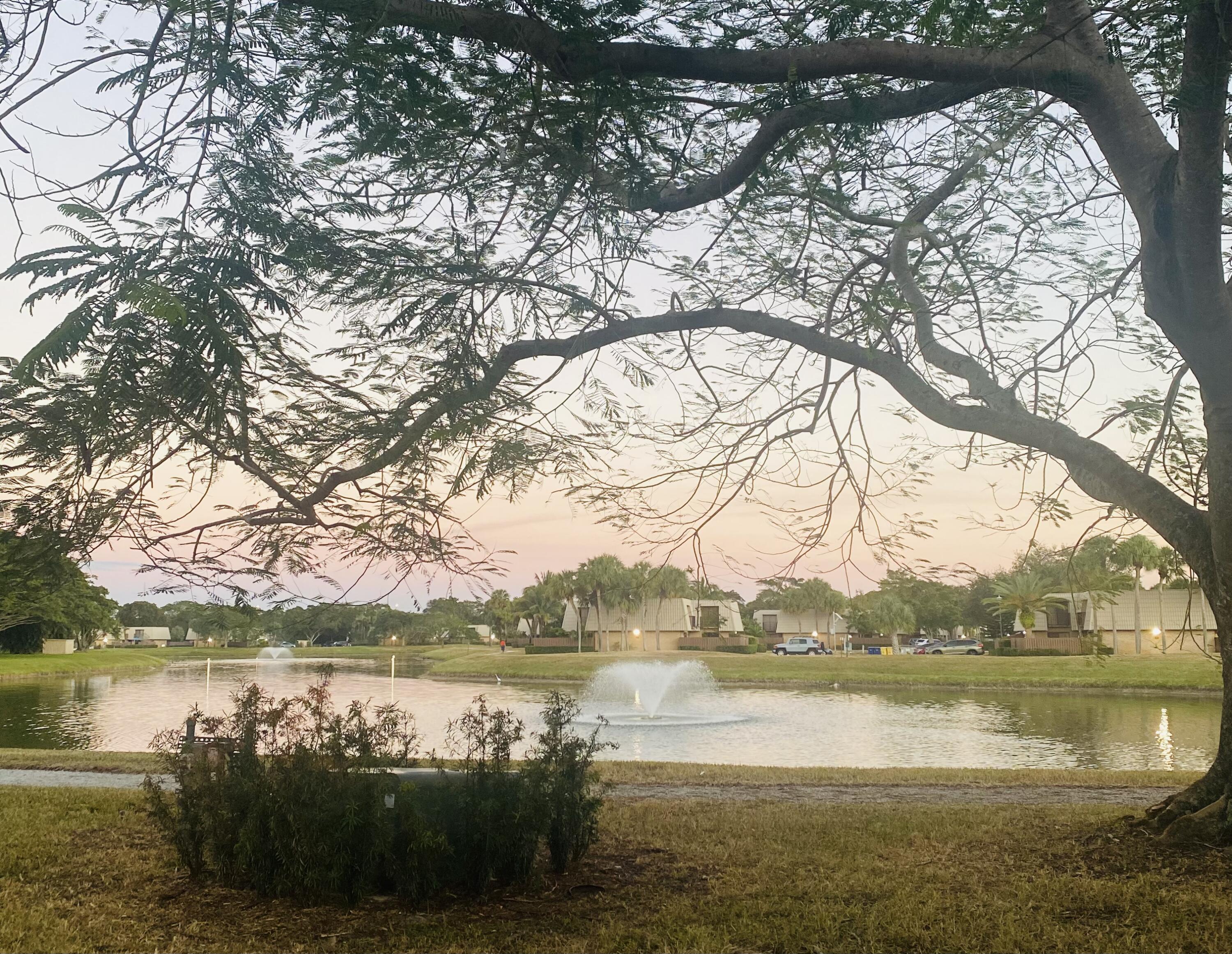 5808 58th Way West Palm Beach, FL 33409 - Photo 3 of 23 a view of lake with green space