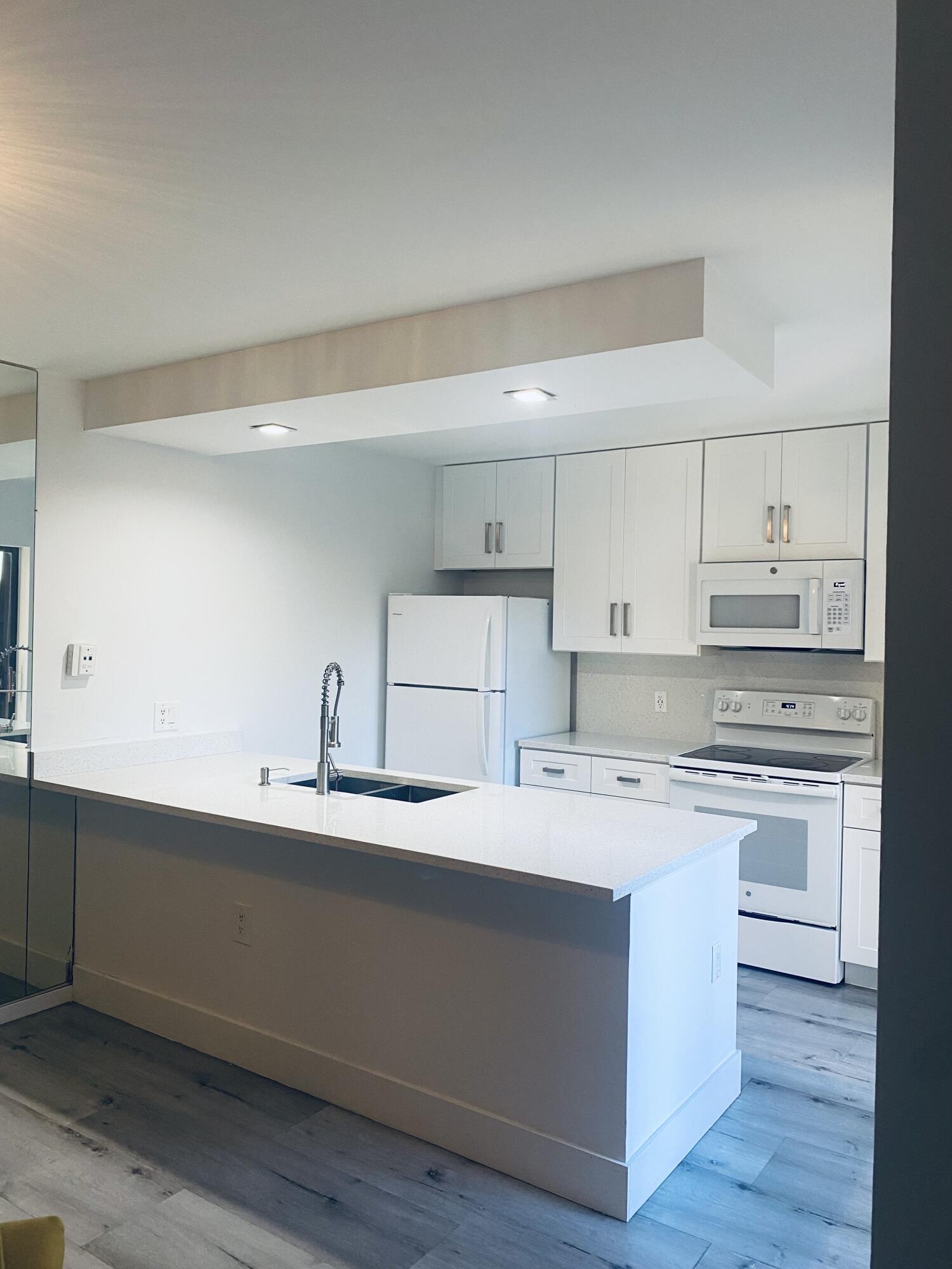5808 58th Way West Palm Beach, FL 33409 - Photo 6 of 23 a kitchen with a sink stove and cabinets