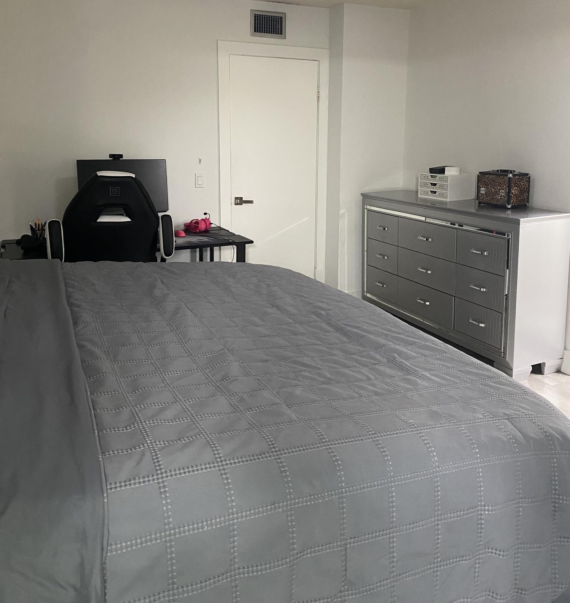 5808 58th Way West Palm Beach, FL 33409 - Photo 10 of 23 a bedroom with a bed and a potted plant