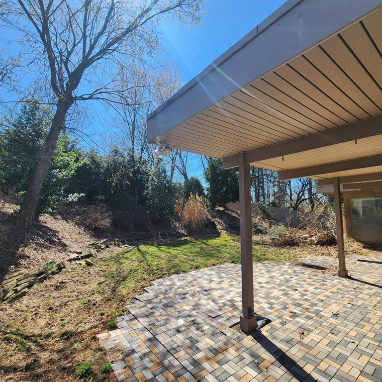 2417 Marbury Road Pittsburgh, PA 15221 - Photo 28 of 31 a view of a patio with table and chairs under an umbrella