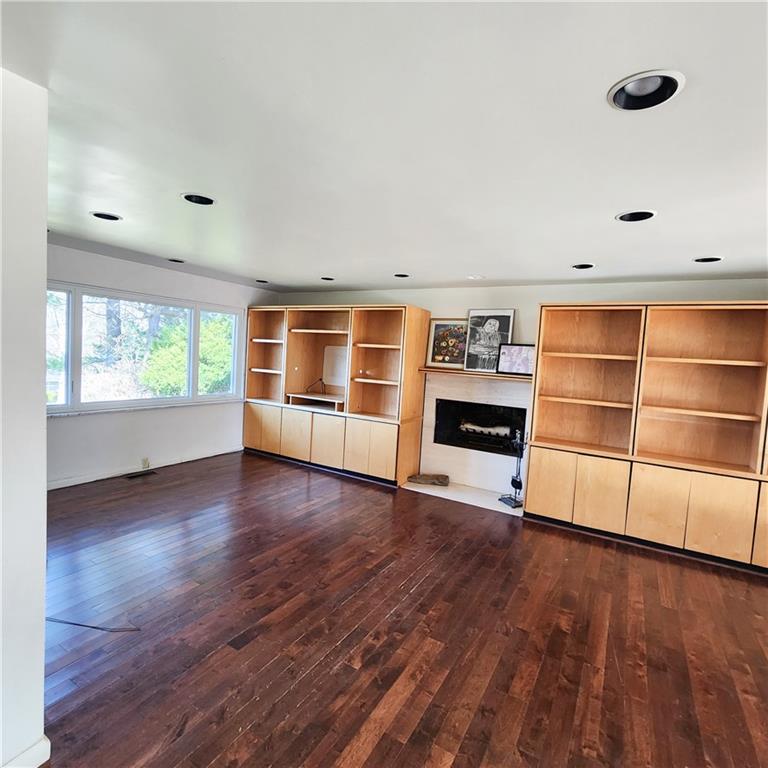 2417 Marbury Road Pittsburgh, PA 15221 - Photo 7 of 31 a view of an empty room with a window and wooden floor