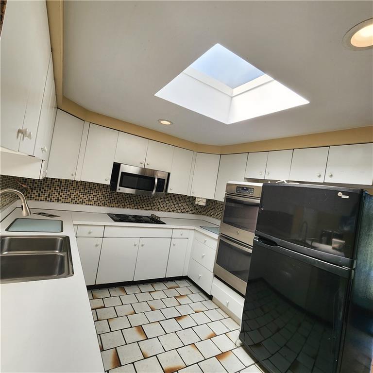 2417 Marbury Road Pittsburgh, PA 15221 - Photo 9 of 31 a kitchen with a sink stainless steel appliances and white cabinets