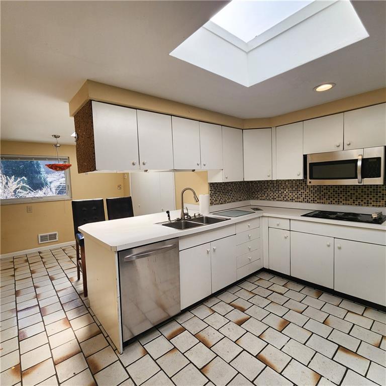 2417 Marbury Road Pittsburgh, PA 15221 - Photo 10 of 31 a kitchen that has a sink and a stove in it