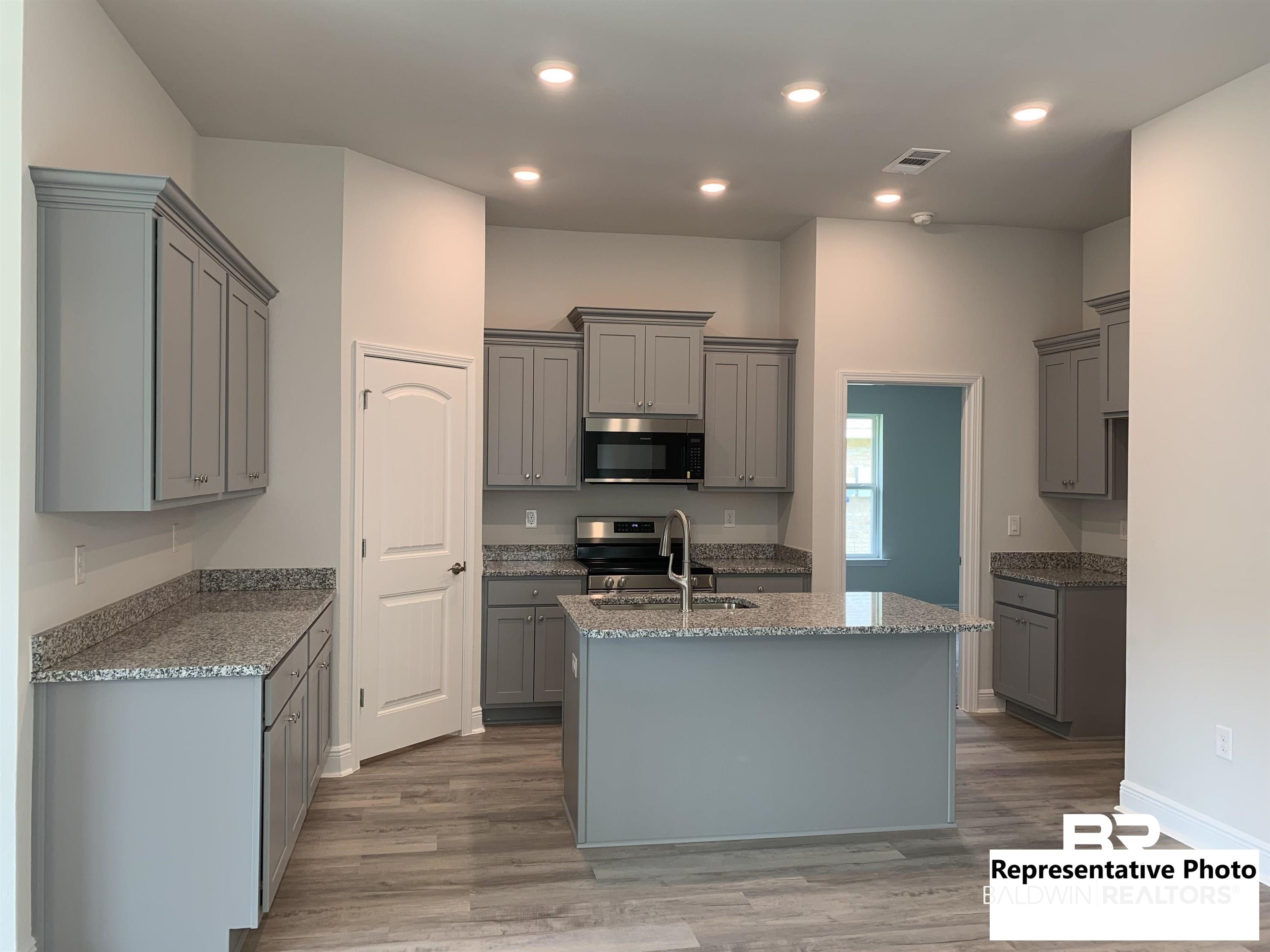 645 Revere Street Foley, AL 36535 - Photo 6 of 14 Kitchen with stainless steel appliances and gray cabinets