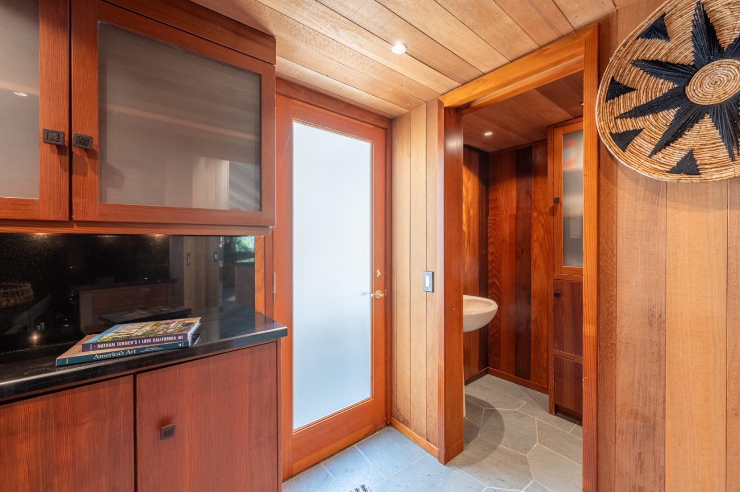 9 Story Road Carmel Valley, CA 93924 - Photo 20 of 60 a view of an empty room and wooden floor and a cabinet door