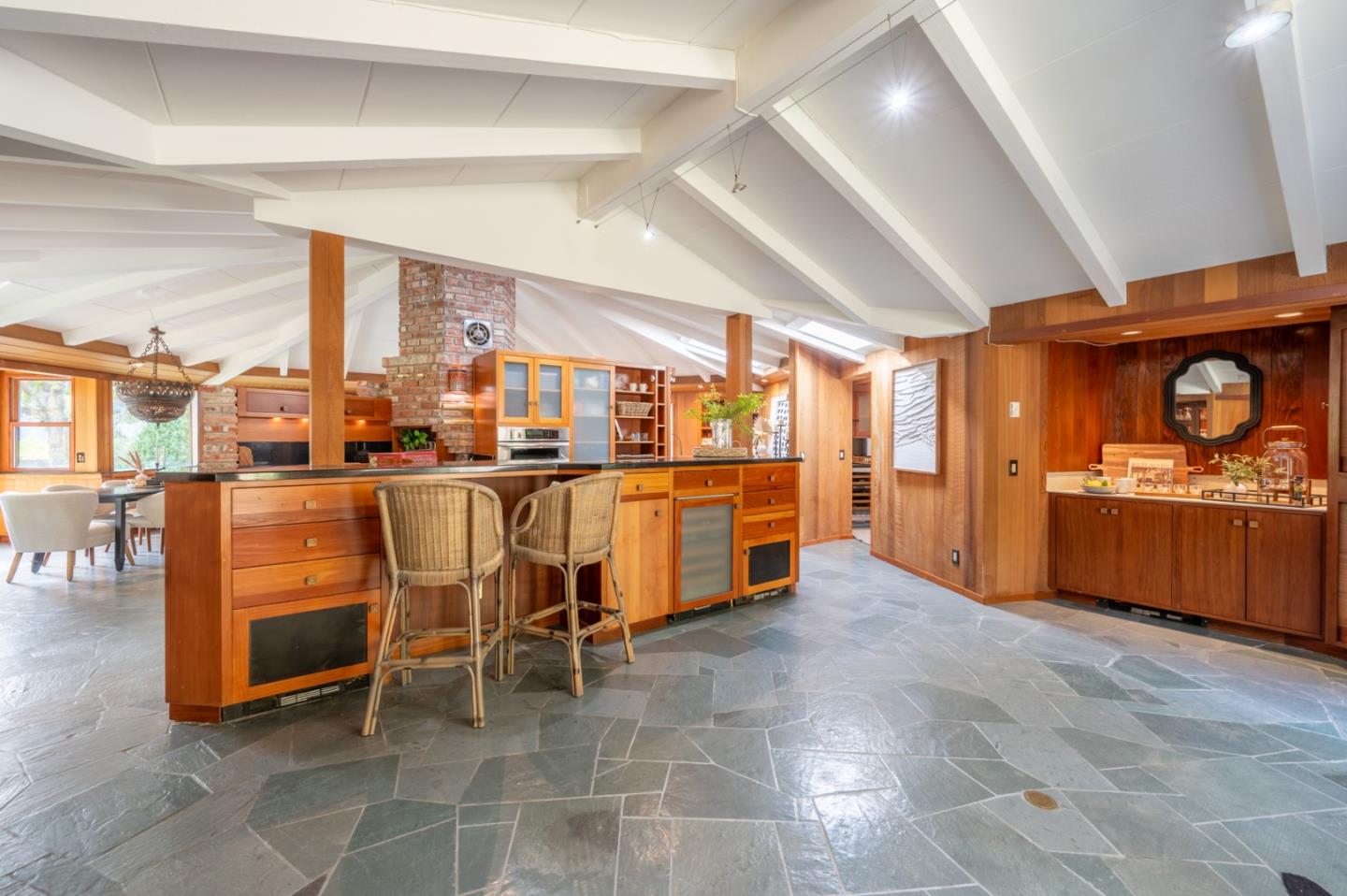 9 Story Road Carmel Valley, CA 93924 - Photo 25 of 60 a dining hall with stainless steel appliances a stove a sink dishwasher with a chair and white cabinets next to a window