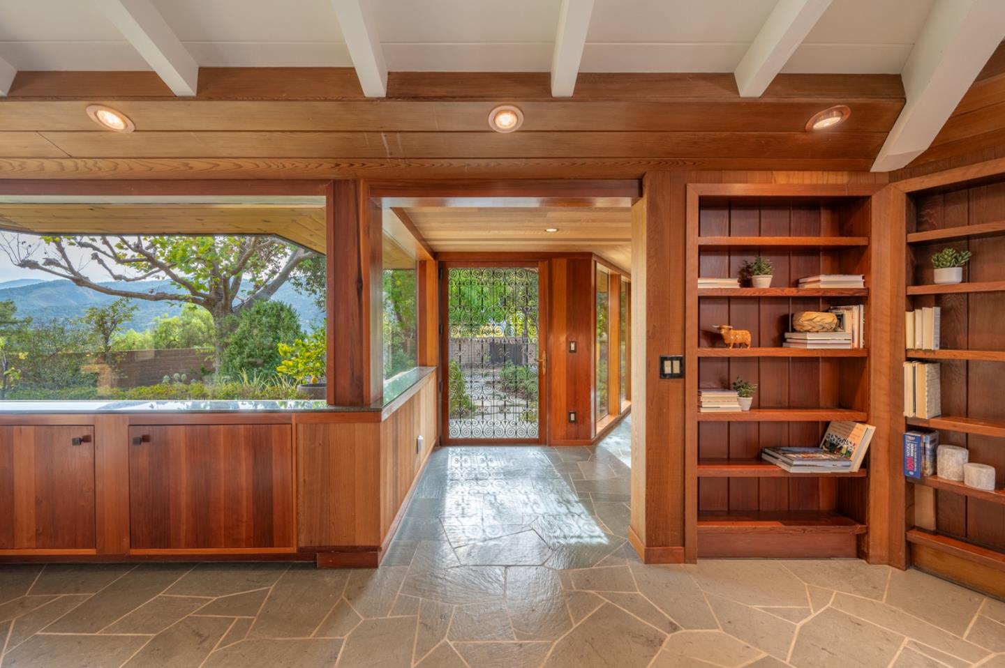 9 Story Road Carmel Valley, CA 93924 - Photo 37 of 60 a hallway with a large window and book shelf