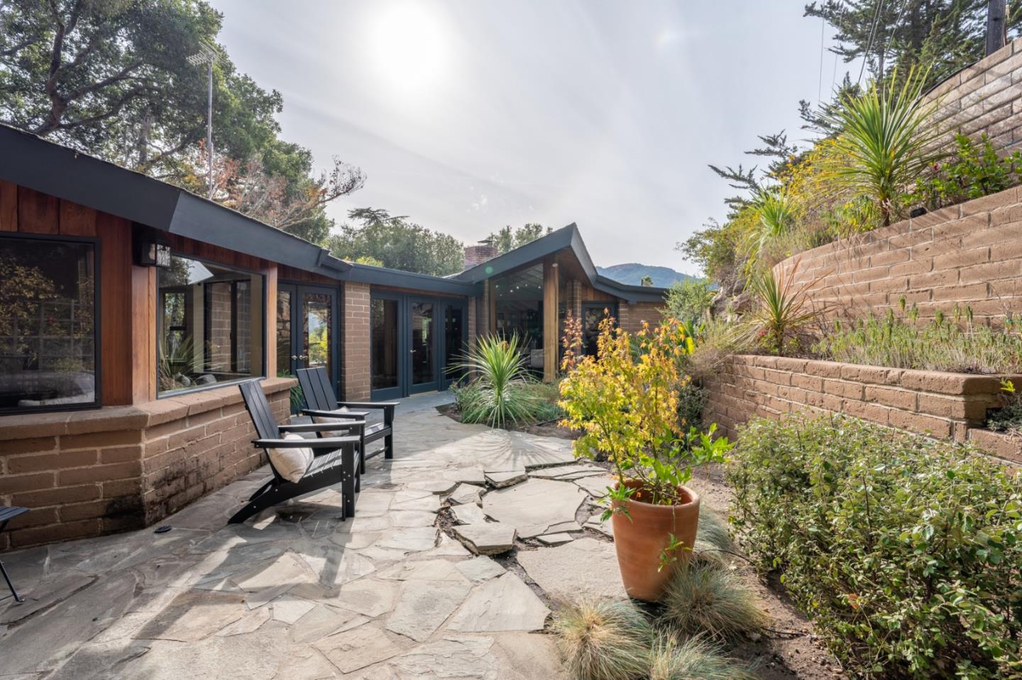 9 Story Road Carmel Valley, CA 93924 - Photo 46 of 60 a view of a house with lounge chair and potted plants