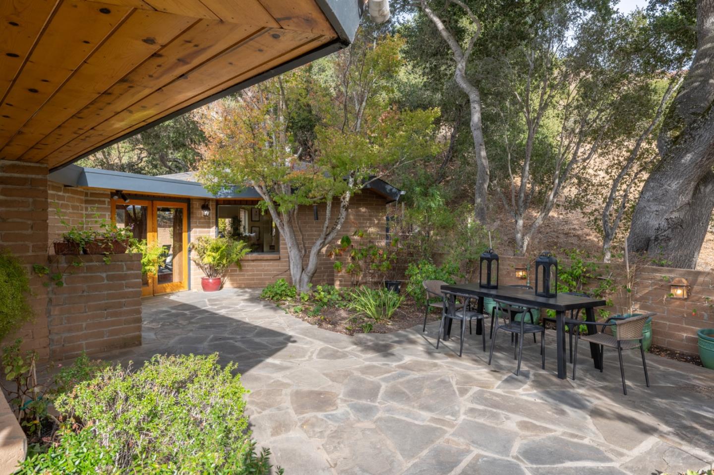 9 Story Road Carmel Valley, CA 93924 - Photo 49 of 60 a view of a patio with table and chairs and potted plants