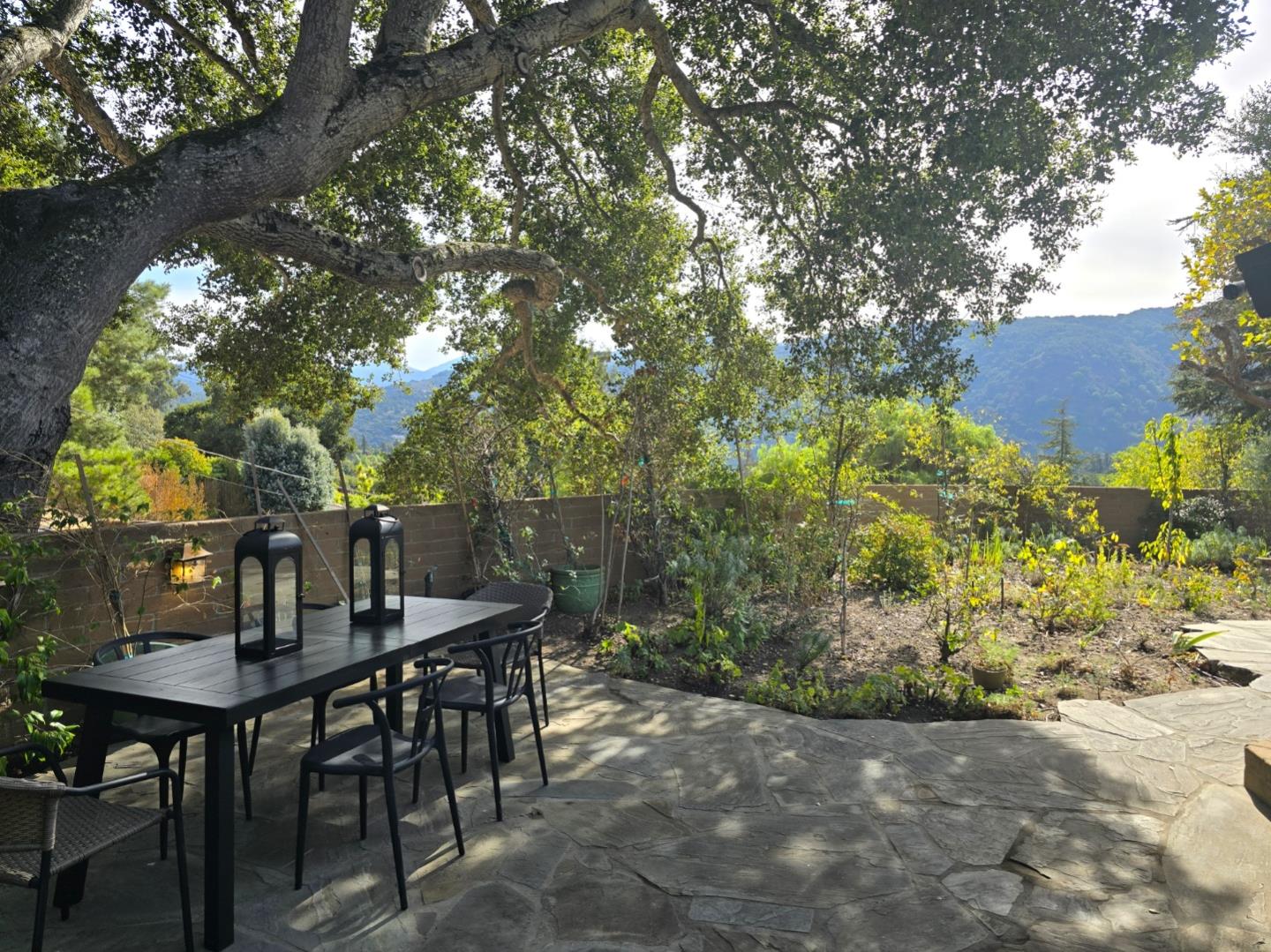9 Story Road Carmel Valley, CA 93924 - Photo 50 of 60 a backyard of a house with table and chairs