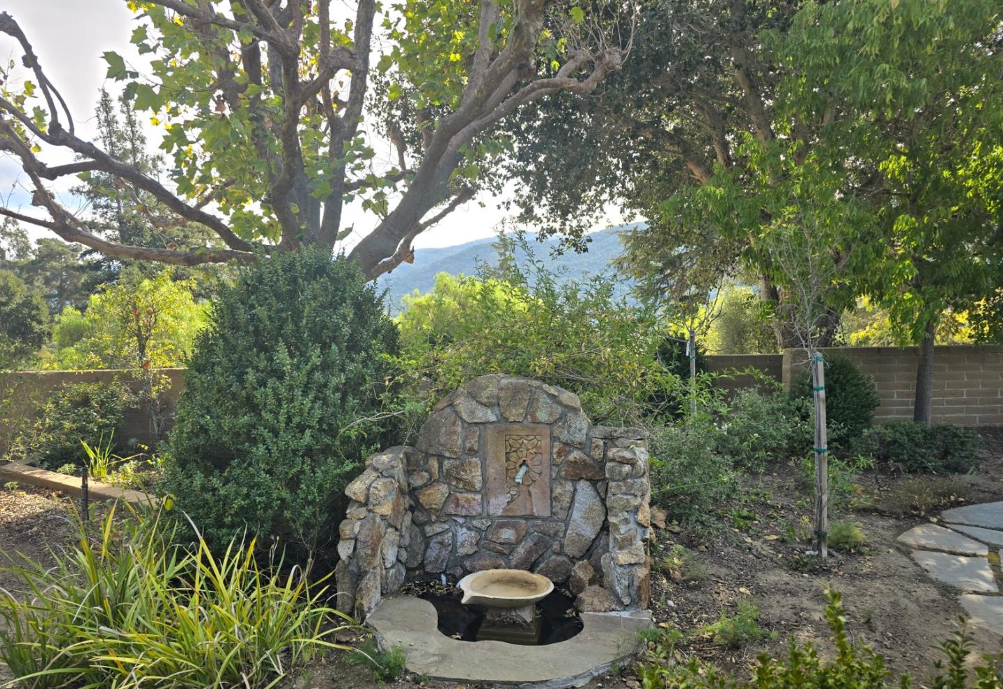 9 Story Road Carmel Valley, CA 93924 - Photo 52 of 60 a backyard of a house with lots of green space and fountain