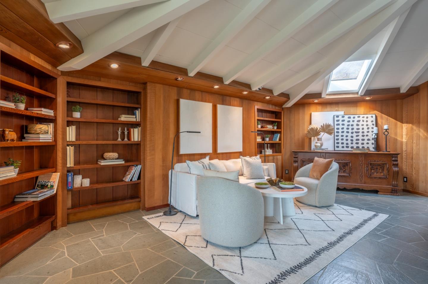 9 Story Road Carmel Valley, CA 93924 - Photo 6 of 60 a living room with furniture a rug and a bookshelf