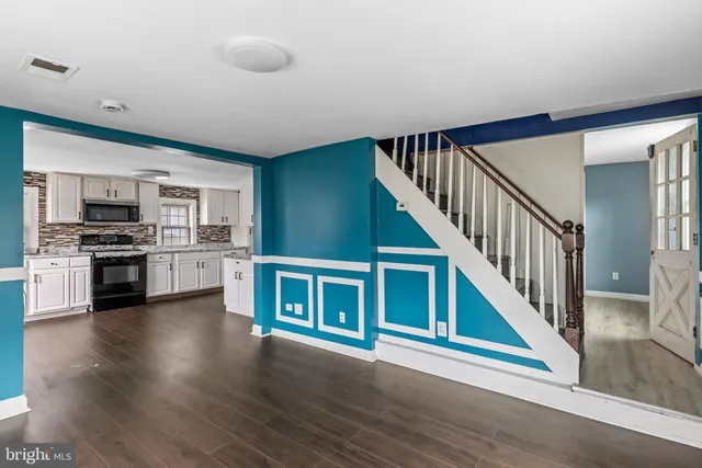 a view of kitchen with cabinets and wooden floor