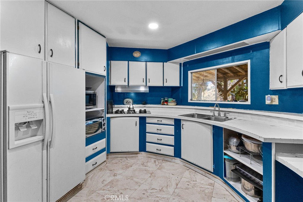 38942 Jubilee Way Fallbrook, CA 92028 - Photo 1 of 55 a kitchen with stainless steel appliances a stove refrigerator sink and cabinets
