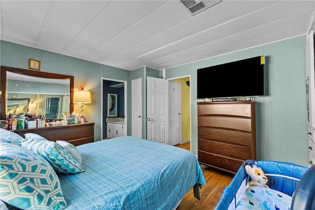 38942 Jubilee Way Fallbrook, CA 92028 - Photo 13 of 55 a bedroom with a bed and a flat screen tv