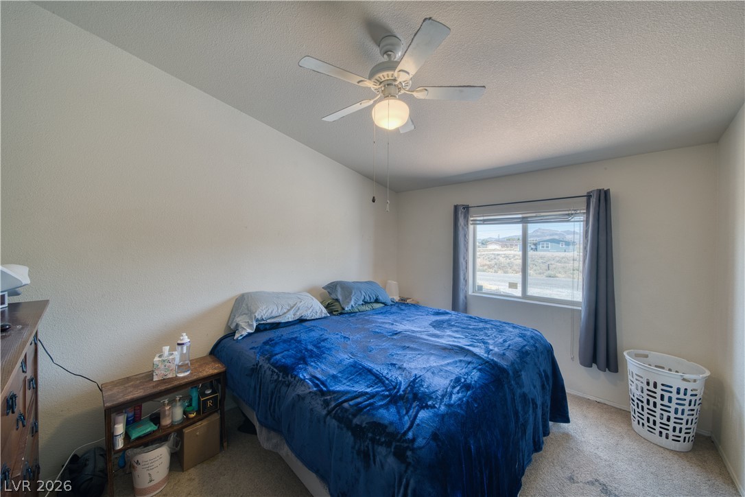 2931 Rio Rancho Drive, Unit 4 Pahrump, NV 89048 - Photo 13 of 21 Comfortable sleeping quarters feature a window with a view and overhead lighting.