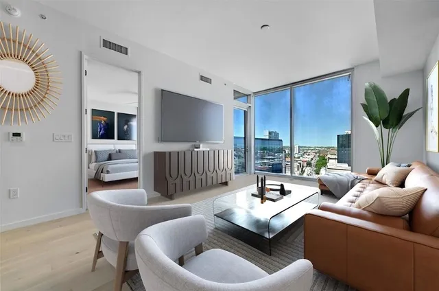 a living room with furniture and a potted plant