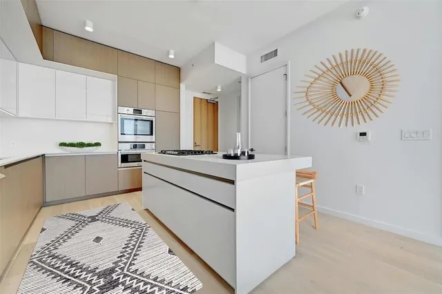 a kitchen with stainless steel appliances granite countertop a sink and cabinets
